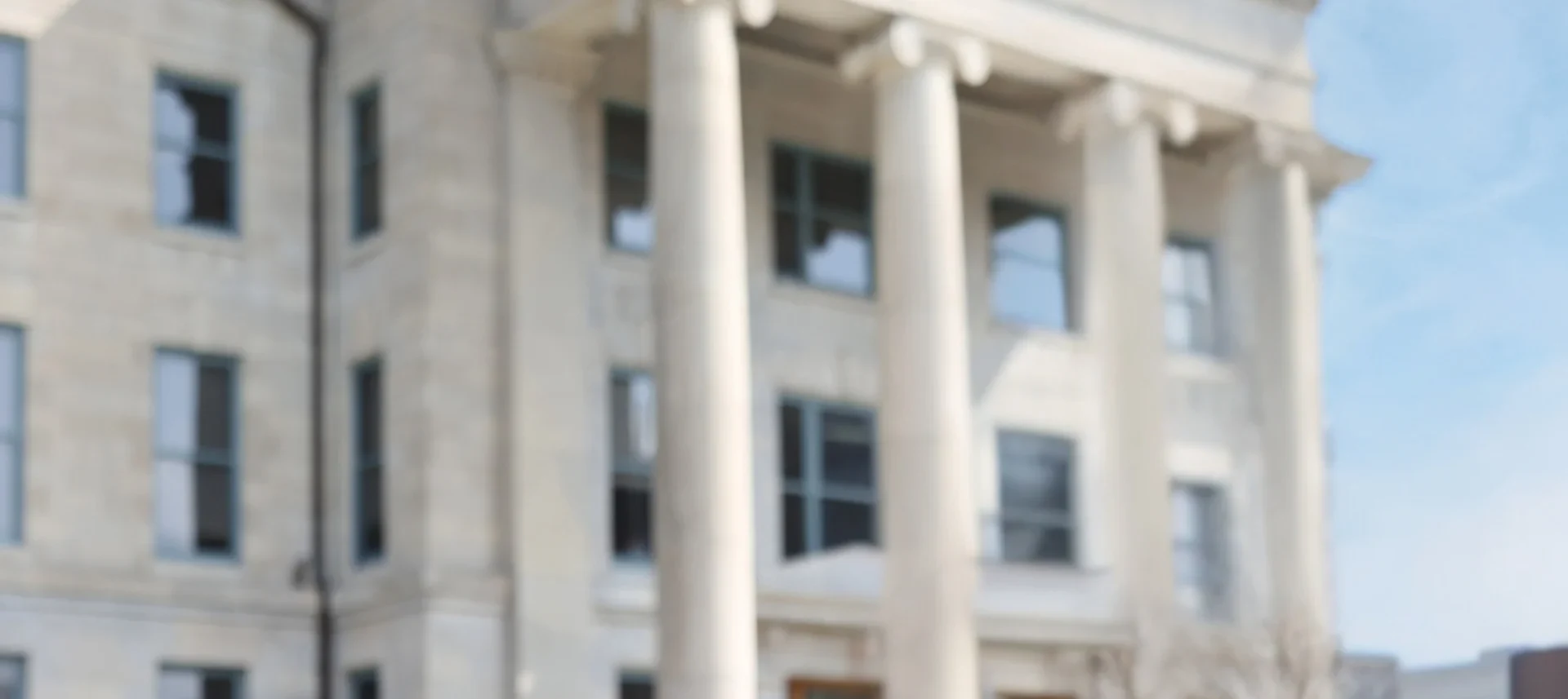 Historic courthouse building with tall columns and windows